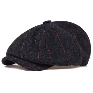 Close-up of dark grey wool newsboy cap with red windowpane check and tweed texture