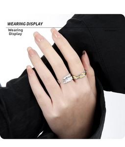 Macro view of dual-tone textured silver rings featuring leaf design and wavy patterns