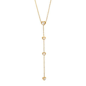 Close-up of golden Y-shaped necklace featuring four heart pendants with sparkling zircons