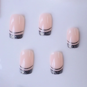 French tip press-on nails with silver glitter and black line on nude pink base