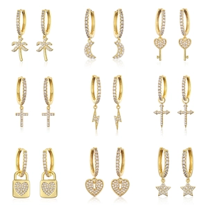 Golden hoop earrings set with micro-pave zircons featuring butterfly and star charms