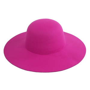 Close-up of vibrant rose pink wool felt fedora showing fine fiber texture and wide brim