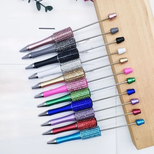 Close-up of sparkling rhinestone beaded pens in various colors for DIY creative writing