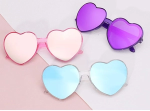 Three pairs of heart-shaped sunglasses in pink, purple, and blue mirror finishes