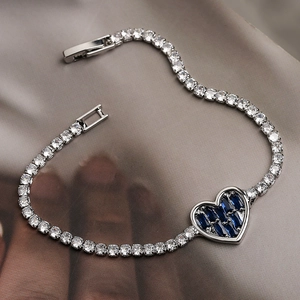 Silver-tone tennis bracelet with heart pendant and blue rectangular gemstone detail