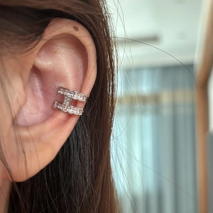 Close-up of silver-tone H-shaped ear cuff with sparkling pavé cubic zirconia inlay