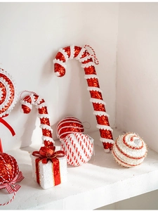 Detail of red and white glitter candy canes and striped ornaments for Christmas tree decor