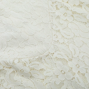Close-up of elegant white floral lace fabric texture with semi-transparent patterns