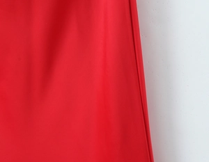 Detailed macro shot of the textured red fabric showing the premium weave and drape