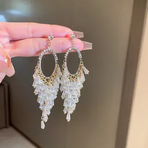 Elegant gold drop earrings with rhinestone studs and tiered crystal tassel fringe