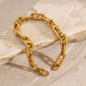 Polished gold stainless steel chain bracelet with V-link design on natural stone