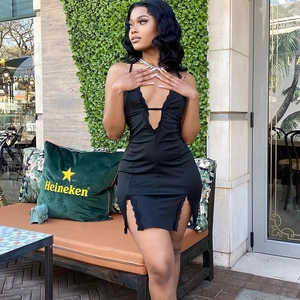 Sexy black bodycon dress with lace trim V-neck and side slits in street style outdoor view