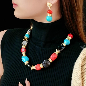 Close-up of vintage irregular geometric necklace and earrings set worn by model