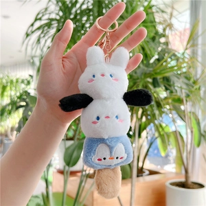 Detail of cute plush keychain with stacked rabbit and penguin mascots on gold ring