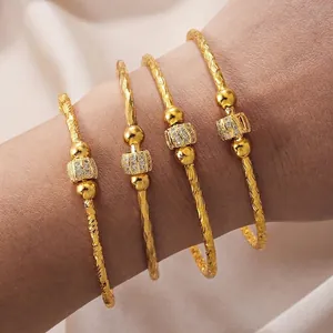 Set of four gold-plated bangles with micro-paved zircons and spiral engraved texture