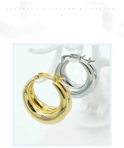 Detail view of hollow crescent-shaped stainless steel earrings in gold and silver finish