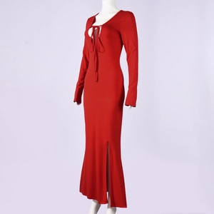 Detail of red long-sleeved dress showing the front lace-up neckline and side high slit