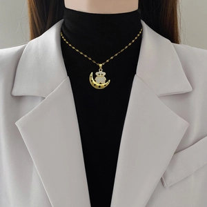 Elegant gold titanium steel necklace featuring a sparkling rhinestone moon and bear pendant