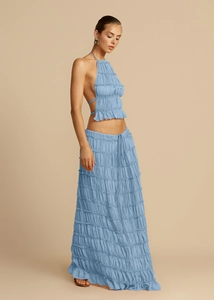 Detail view of light blue halter backless top and tiered ruffle maxi skirt with pleated texture