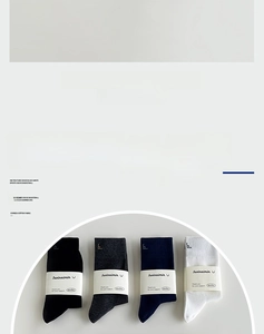 Detail of four pairs of combed cotton crew socks in black, grey, navy, and white