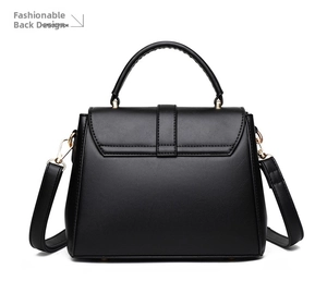 Detail view of the black soft leather handbag back with golden hardware and adjustable strap