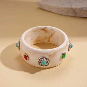 Detail of marble pattern bangle with vintage engraved metal turquoise stone settings