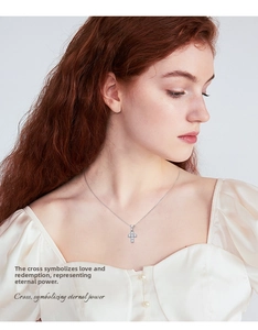 Classic moissanite cross pendant necklace in S925 silver worn by a model on the neckline