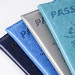 Detail of embossed PU leather passport covers in navy, blue, silver and teal colors