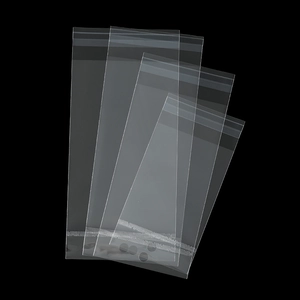Close-up of clear OPP self-sealing bags in multiple sizes on a professional black background
