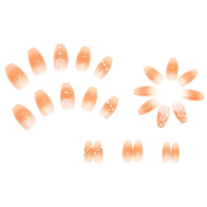 Press-on nails featuring 3D white flowers, pearls and peach gradient ballerina design
