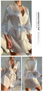 Detail view of white satin robe showing V-neck design and silky tie belt texture
