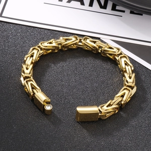 Detail of gold Byzantine chain bracelet featuring a secure magnetic clasp on black surface