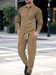 Detail of khaki corduroy texture on men's long sleeve polo and drawstring cargo pants set