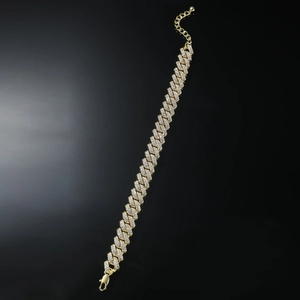 Iced out gold Cuban link anklet for men with sparkling crystals on black background