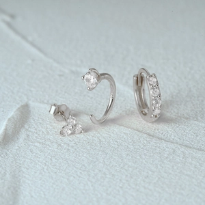 Macro shot of silver 925 sterling silver earring set with clear zircon stones on stone
