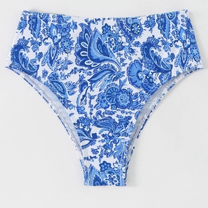 Detail of high-waisted bikini bottoms featuring blue and white porcelain floral patterns