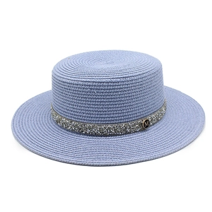 Light blue woven straw hat with silver rhinestone band and golden M logo for sun protection