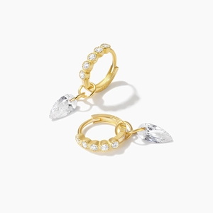 Detailed close-up of S925 sterling silver stamp on gold teardrop earrings with zircons