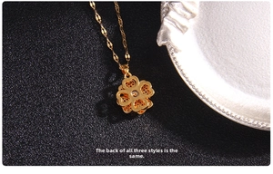 Close-up of gold clover necklace showing the intricate hollow-out design on the back