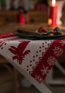Close-up of festive jacquard table runner with reindeer and snowflake patterns