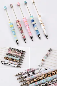 Close-up of DIY beaded pens with leopard, floral and creative pattern prints