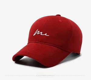 Side view of dark red cotton baseball cap featuring white embroidered 'me' text on front