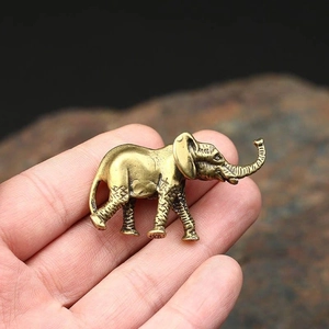 Miniature vintage brass mammoth elephant figurine with detailed texture and curled trunk