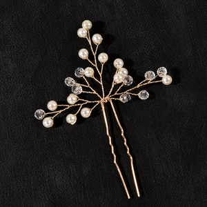Detailed close-up of handmade bridal hair pin with golden wire pearls and crystals