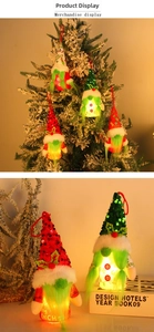 Detail of glowing Grinch Christmas gnome pendant with LED light and sequin hat