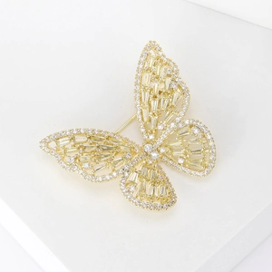 Macro view of gold butterfly brooch with hollow-out design and micro-set cubic zirconia