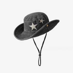 Detail of star patches and washed denim texture on a western-style cowboy hat