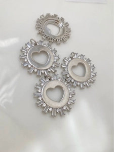 Detailed view of silver heart hollow pendants with rectangular zircon setting for DIY jewelry