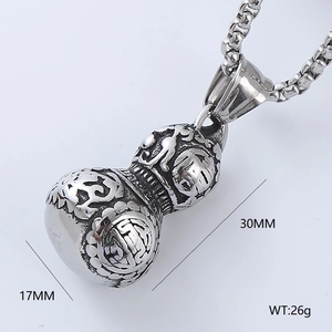 Close-up of vintage silver gourd pendant with dragon clouds and Fu character engraving