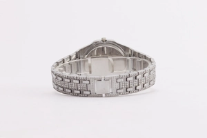 Detail of silver octagonal watch with full diamond paving and calendar display